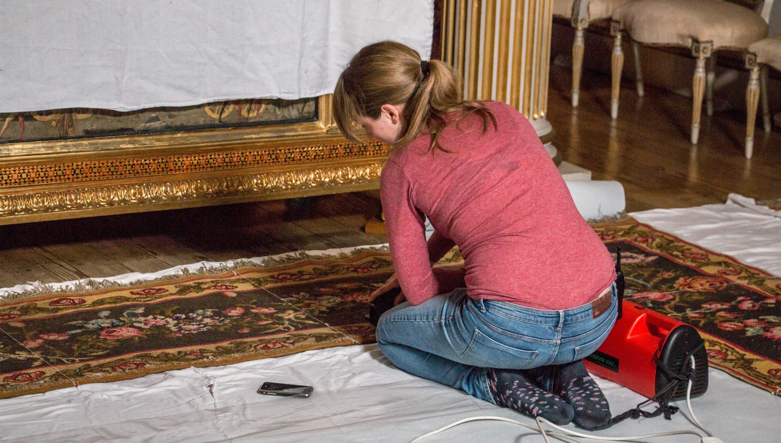 House steward Ellie Hobbs cleans the state bedroom carpet at Blickling Hall in Norfolk, where the trial will take place