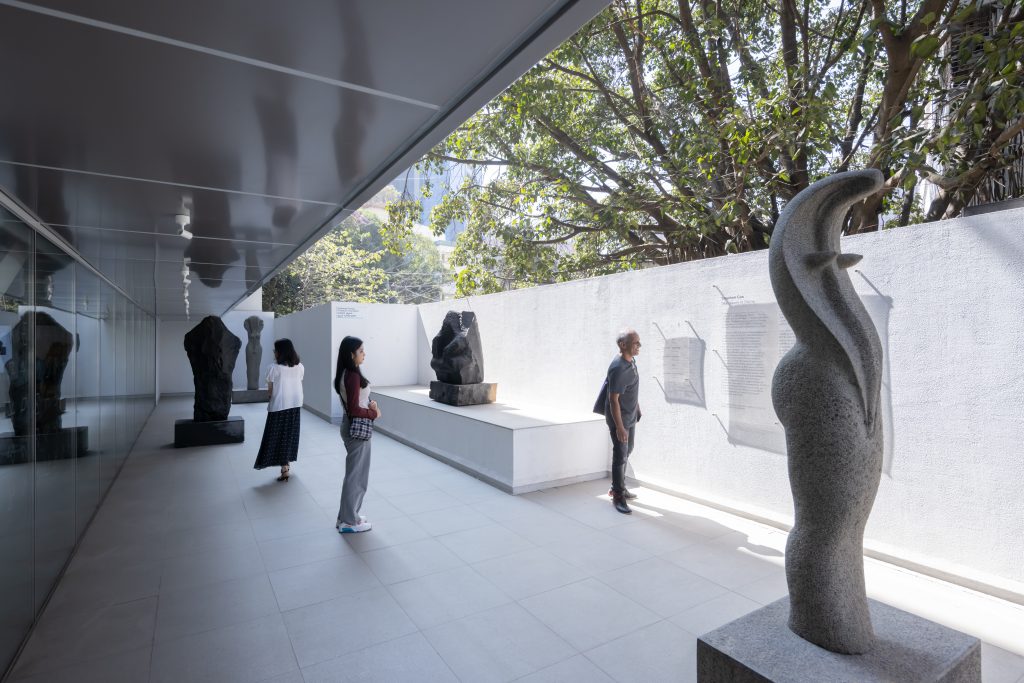 People looking at sculptures on an outdoor terrace